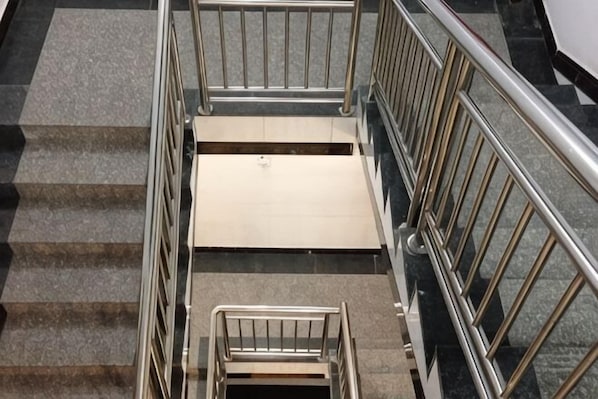 A set of outdoor stairs with metal railings and a flat landing area.