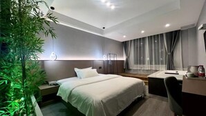 A modern hotel room with a large bed, bedside tables, a desk, and a bathroom. - an County Zhengxing Business Hotel (Mianyang)