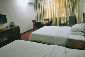 A hotel room with two beds, a desk with a computer and a kettle, a dining table with chairs, and a window with curtains. - Shiniuzhai Pinru Villa (Pingjiang)