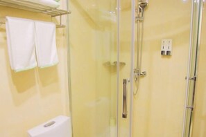 A glass-enclosed shower with a handheld showerhead, a towel rack with two towels, and a white toilet. - Shiniuzhai Pinru Villa (Pingjiang)