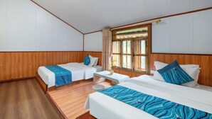 A hotel room with two single beds, a small table, and a window with curtains. - By Chance Bar&Inn (Zhaoping)