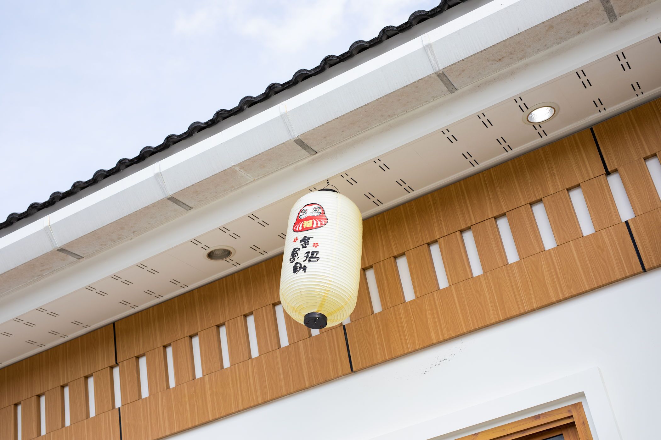 A traditional Japanese building with a wooden exterior and a tiled roof.