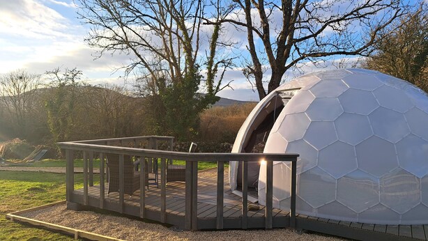 A geodesic dome structure with a wooden deck and seating area. - Burren Glamping Dome - 1 bed lux Stay Pets Welcome (Kiltacky More)