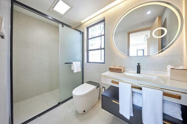 A modern bathroom with a glass shower enclosure, a white toilet, a vanity with a mirror, and a towel rack. - Otter Home (Zhoushan)