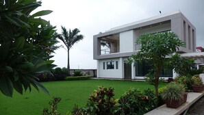 A modern two-story building with a flat roof, large windows, and a well-maintained lawn. - Chandan Van Club and Resort - Navsari (Navsari)
