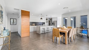 A modern kitchen with white cabinets, a central island, and pendant lighting. - Oasis at Sapphire,Pool, Pet Friendly, Bike Paths, Family Fun (Sapphire Beach)