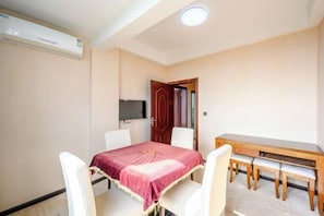 A room with a bed, a desk, and a chair.