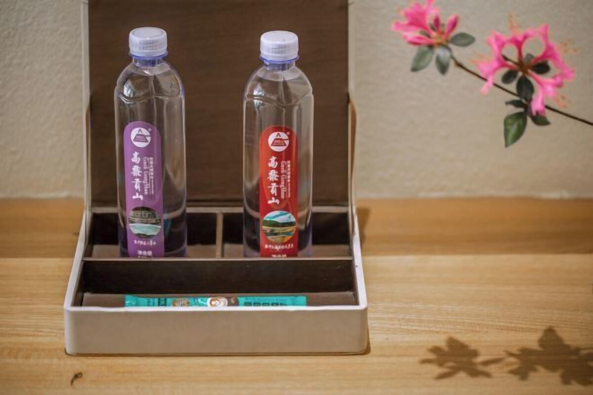 A wooden box with two bottles of water and a box of tea.