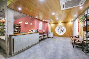 A reception area with a wooden ceiling, a reception desk, and a circular wall decoration.