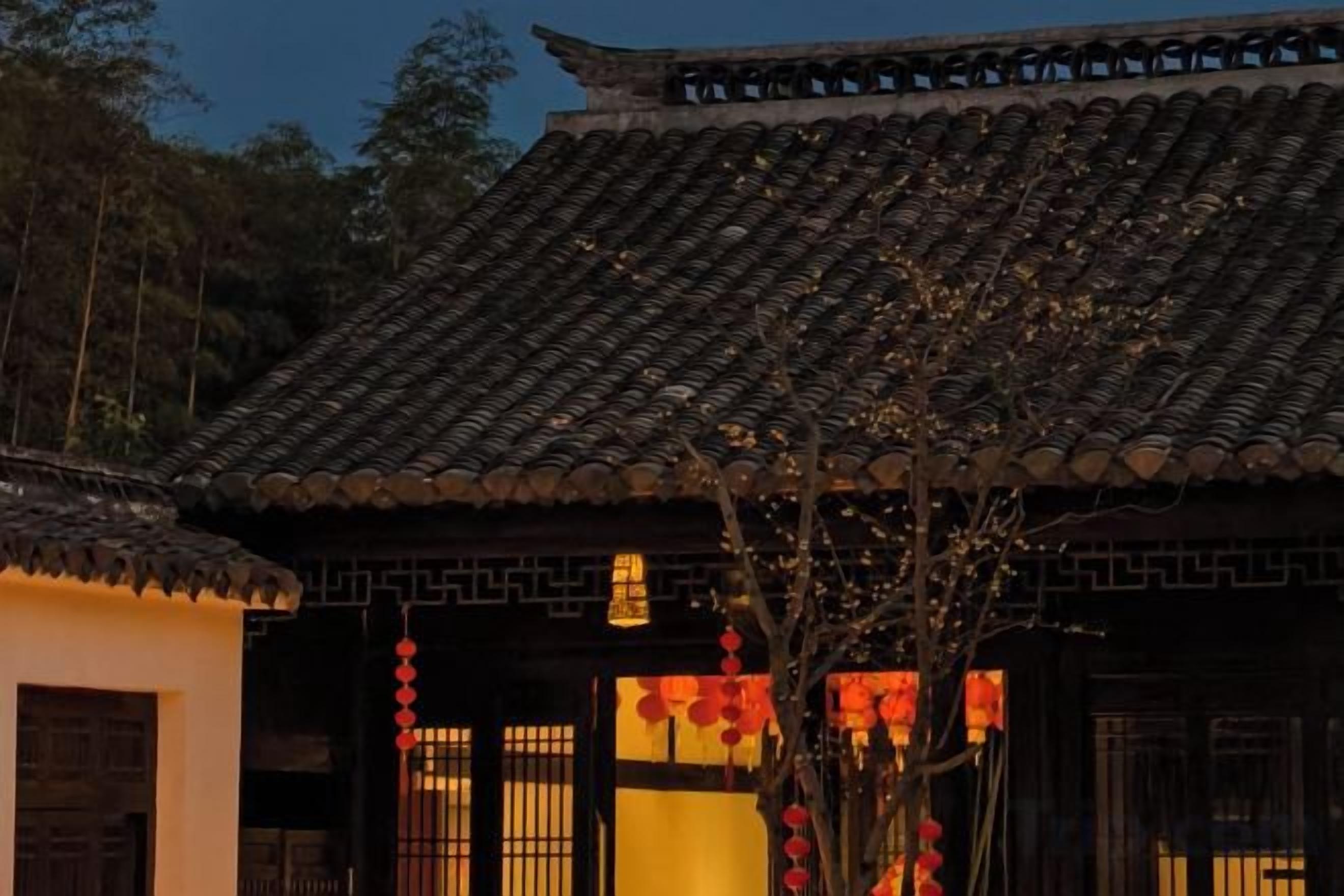 A traditional building with a tiled roof and wooden doors.
