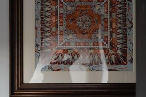 A framed artwork with a geometric and floral pattern, displayed on a wall. - Huzhou Biocountry Resort (Changxing)