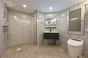 A modern bathroom with a shower, a sink with a mirror, and a trash bin. - Chongqing Hotel (Shenzhen Luohu Port Guomao Subway Station) (Shenzhen)
