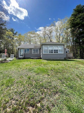 A two-story house with a front deck and a small porch.