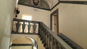 A grand staircase with ornate balustrades and a decorative ceiling. - Elegant apartment with Parking, A/C, Wi-Fi, in the old town (Pistoia)