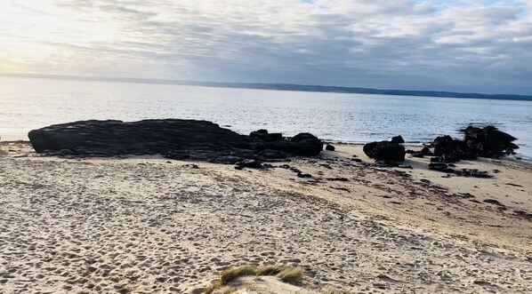 Enjoy a serene beach experience with calm waters and a natural shoreline.
