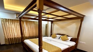 A four-poster bed with a wooden frame and a quilted bedspread.