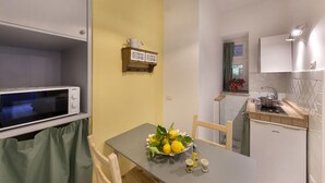 A compact kitchen with a microwave, a sink, and a small countertop.