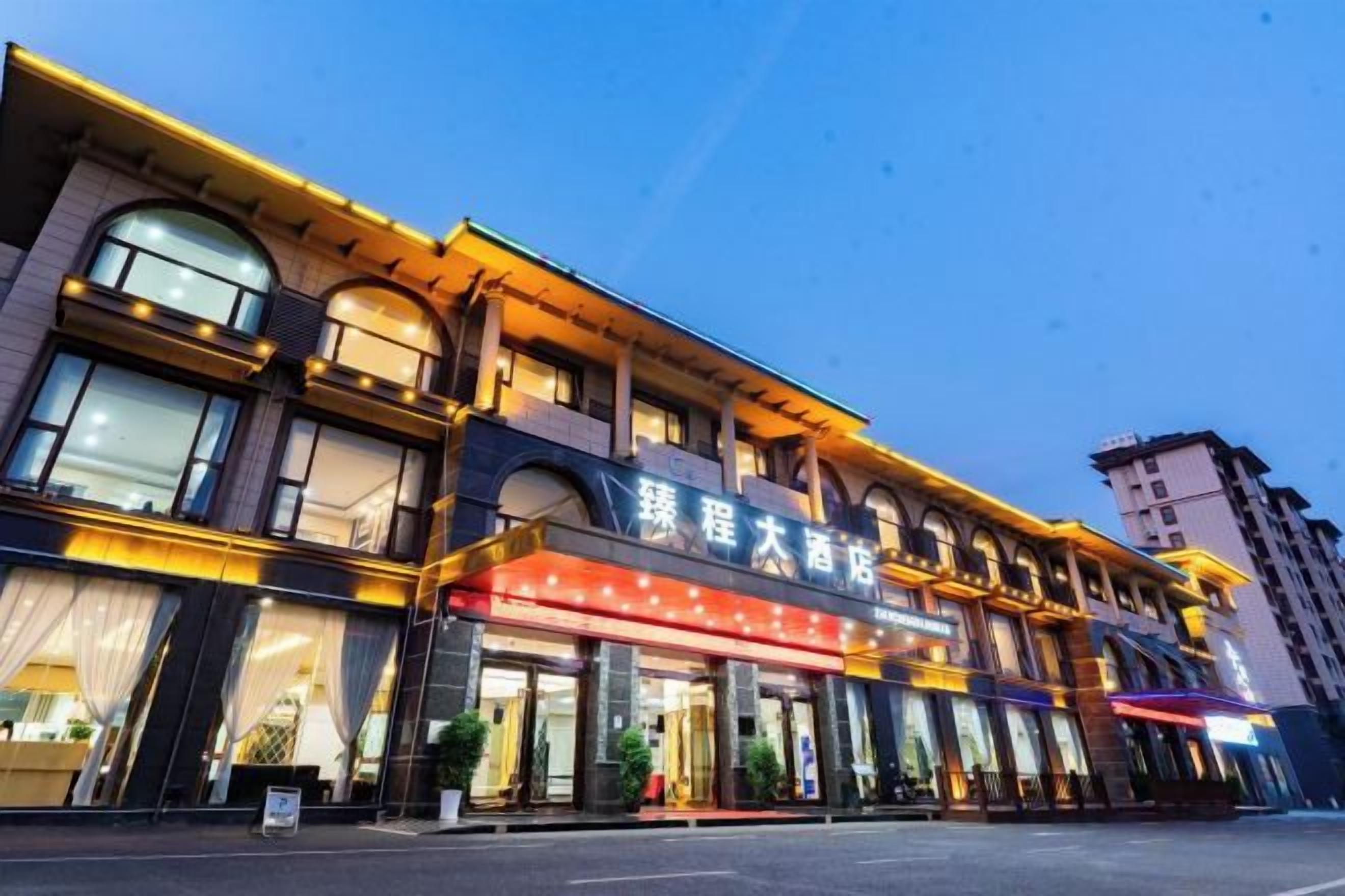 A multi-story hotel with a prominent marquee sign, large windows, and a classic architectural design.