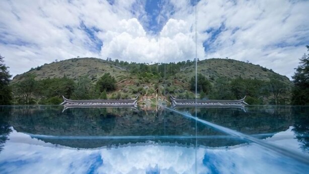 A serene lake with a traditional bridge and a hill in the background. - Sisigu View Inn (Lijiang)