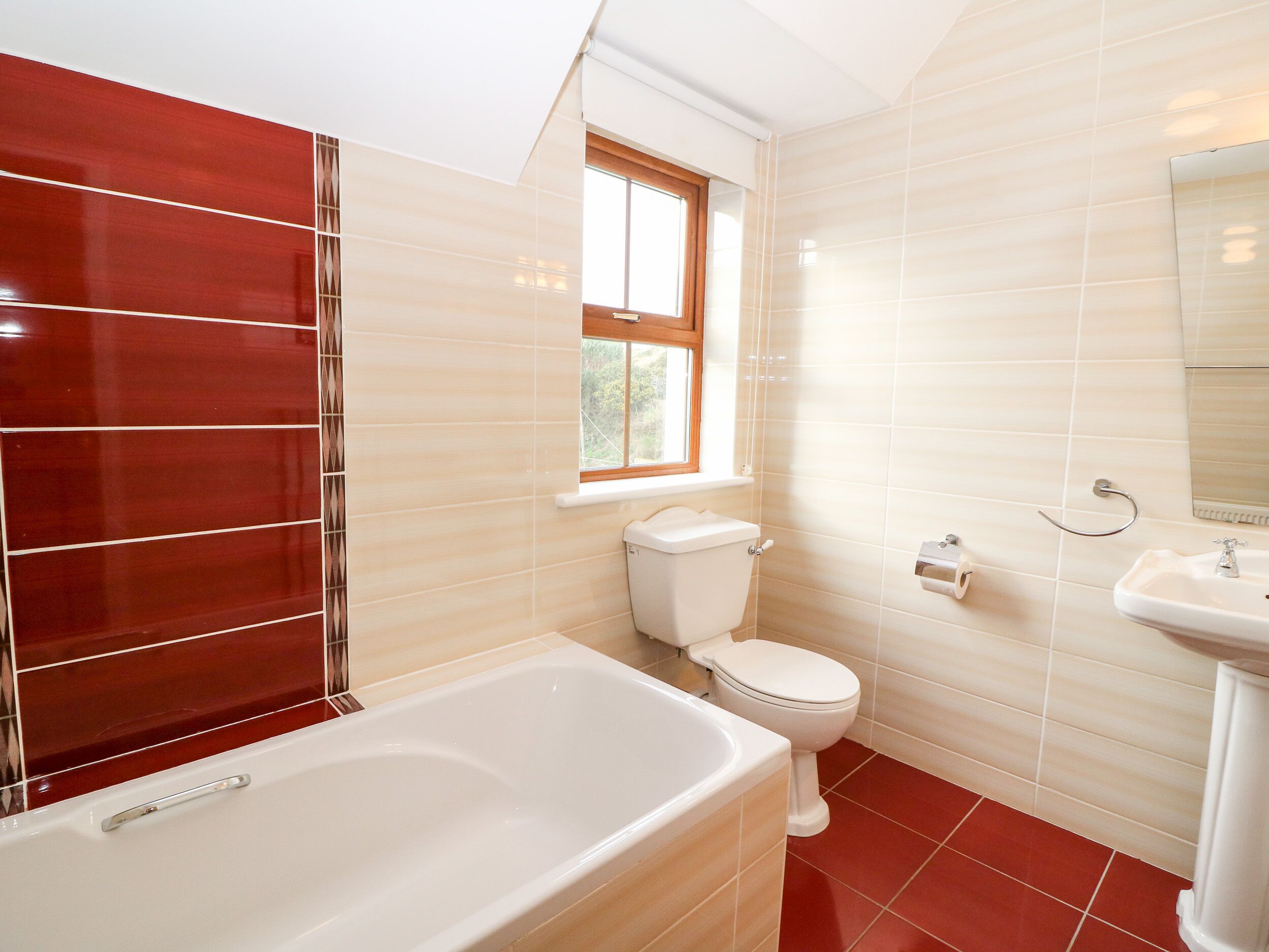 A bathroom with a bathtub, toilet, and sink.