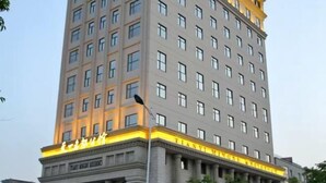 A tall hotel with multiple floors and a prominent entrance. - Tianyi Mingdu Mansion (Longyao County)