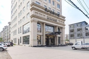 A multi-story hotel with a prominent entrance, large windows, and a modern architectural design.