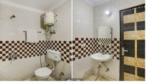 A bathroom with a toilet, sink, and shower. The walls have a checkered tile pattern. - Victoria Palace (New Delhi)