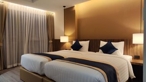A large bed with two side tables, a headboard with integrated lighting, and a view of the room's interior. - Hi Chiangmai Hotel (Chiang Mai)