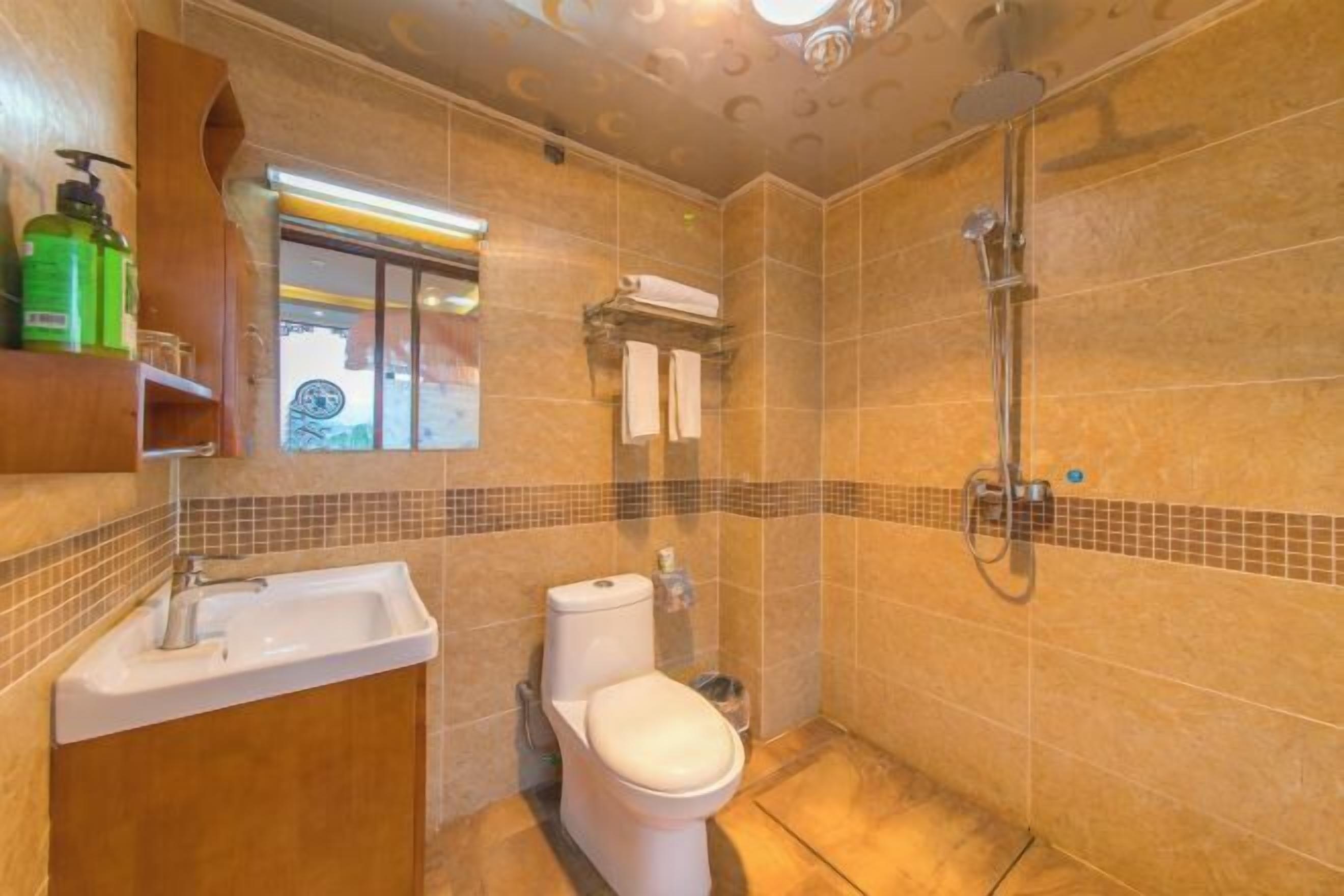 A bathroom with a sink, toilet, and shower.