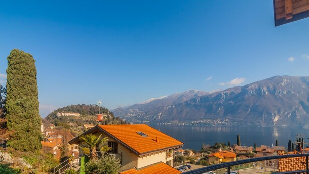 A coastal village with traditional architecture, a prominent mountain in the background, and a clear view of the sea. - Incanto Apartment by Wonderful Italy (Bellagio)