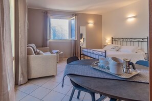 Enjoy a comfortable stay in this well-appointed room with a seating area, coffee amenities, and a cozy bed.