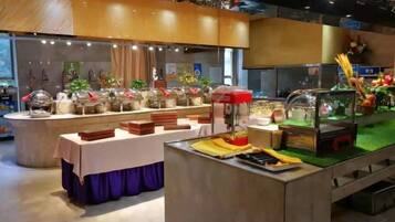 A buffet setup with various food stations and a central serving area.