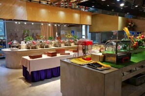 A buffet setup with various food stations and a central serving area.
