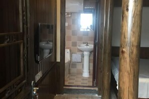 A narrow hallway leading to a bathroom with a sink and mirror. - Bishan Zhoujiayuan Farmhouse (Yi County)