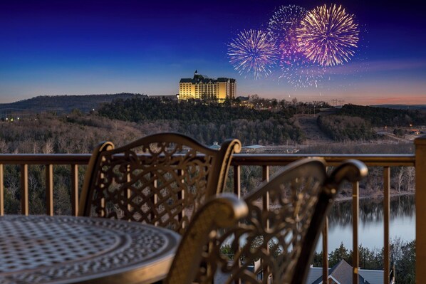 Enjoy a peaceful evening view from this serene balcony overlooking a tranquil lake.