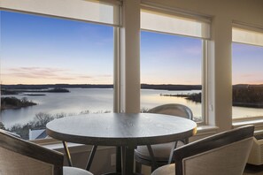 Enjoy a serene view of the water and distant landforms from this room's large window.