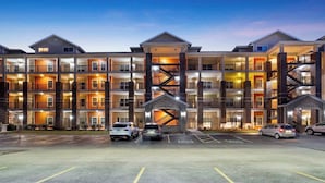 A multi-story hotel with a central staircase, multiple balconies, and a parking lot. - New Listing Ozark Views at Majestic - Perched on the Hills (Branson)