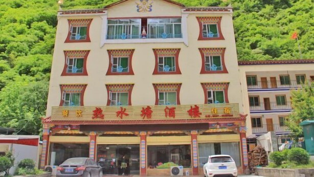 A multi-story building with a traditional architectural style, featuring a prominent entrance with a decorative awning and a signboard. - Reshuitang Hotel (Li County)
