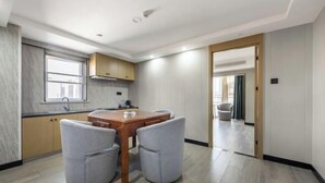 Une cuisine moderne avec une table à manger et des chaises, une fenêtre et une vue sur la ville.