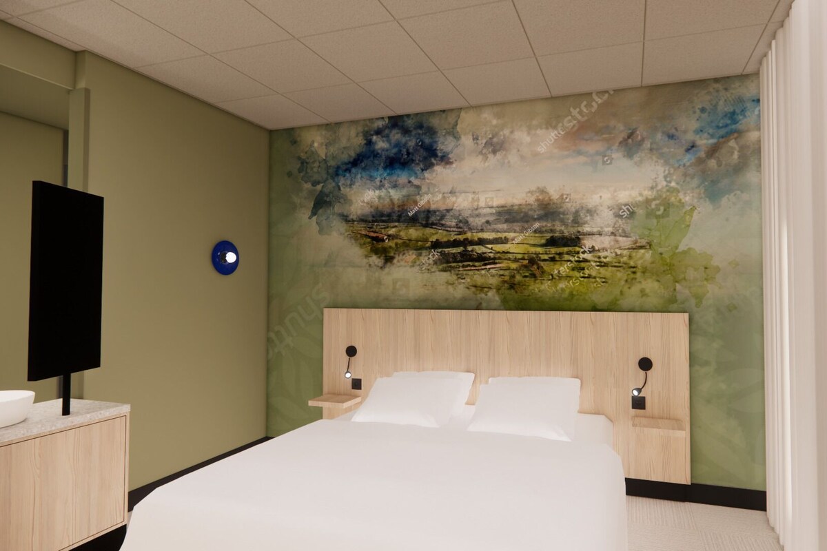 A bedroom with a bed, a bedside table, a wall-mounted TV, and a painting on the wall.