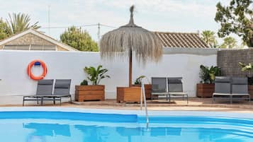 Seasonal outdoor pool, open noon to 8:00 PM, pool umbrellas