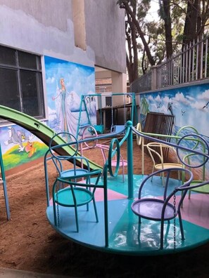 A playground with colorful equipment and a mural in the background. - Beautiful 2-bed Apartment in Nairobi (Nairobi)