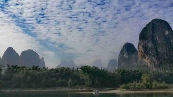 A coastal landscape with prominent limestone cliffs and a calm body of water.
