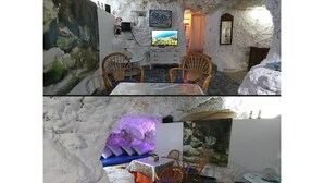 Un comedor con pared de piedra, sillas de madera, una mesa y un televisor.