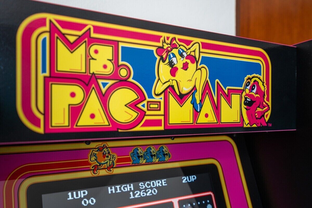 A vintage arcade machine with the title "Mr. Pac-Man" and a high score display.