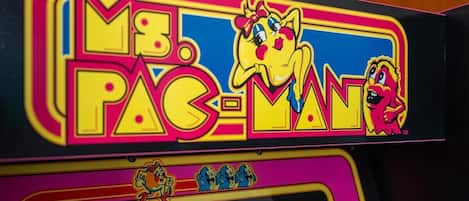 A vintage arcade machine with the title "Mr. Pac-Man" and a high score display.