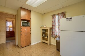 Eine kleine Küche mit Mikrowelle, Toaster und Kühlschrank.