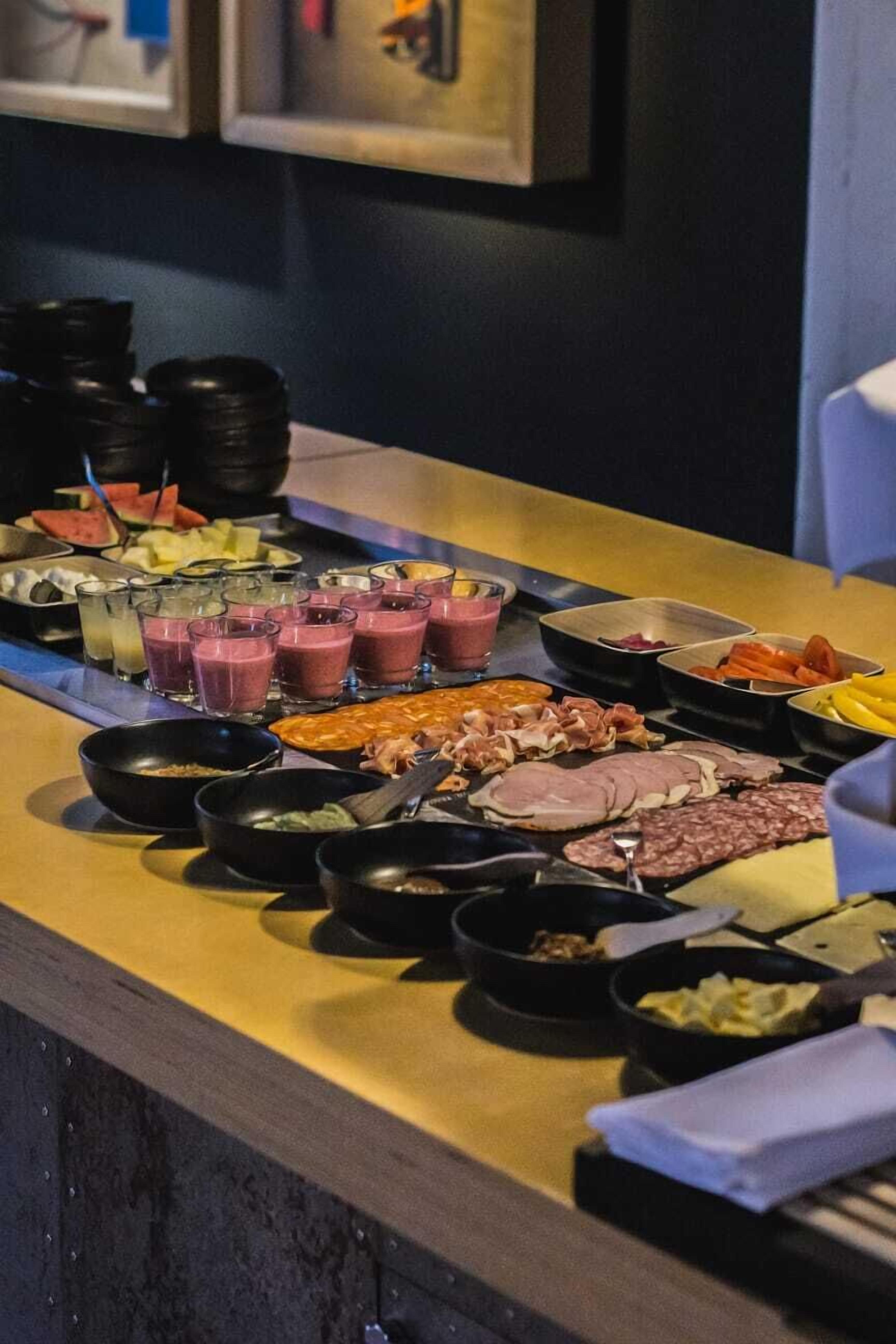 A buffet table with various food items and beverages.