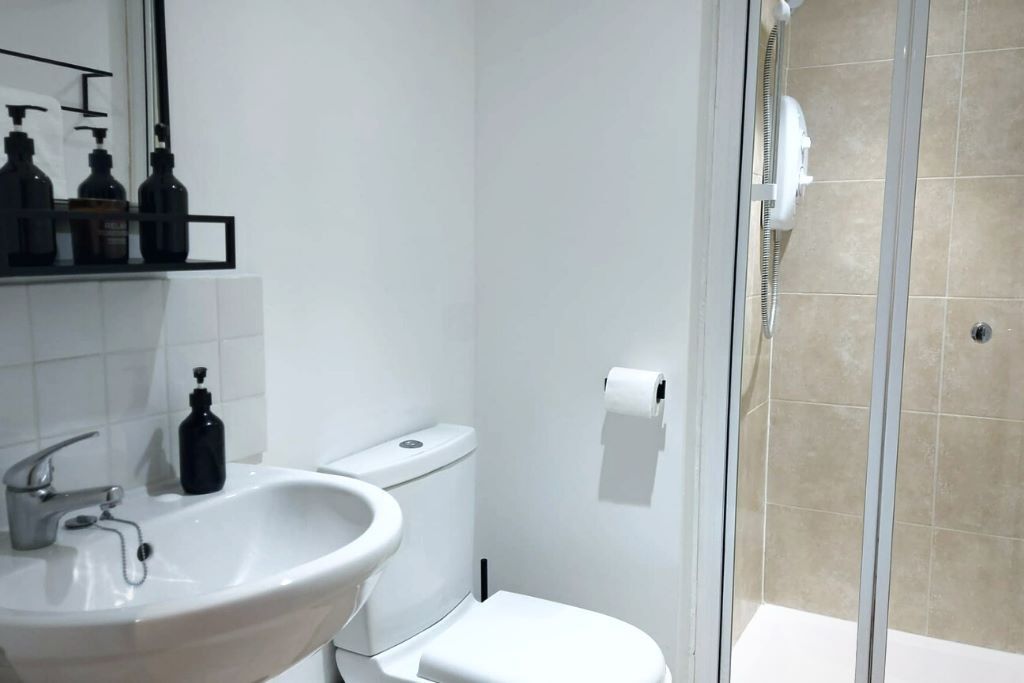 Shower, hair dryer, towels, shampoo