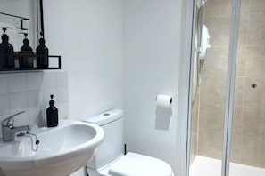 Shower, hair dryer, towels, shampoo